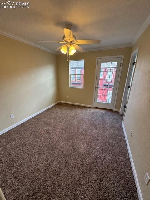 carpeted empty room featuring crown molding and ceiling fan