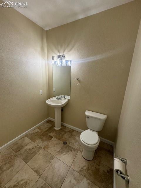 bathroom featuring sink, tile patterned floors, and toilet