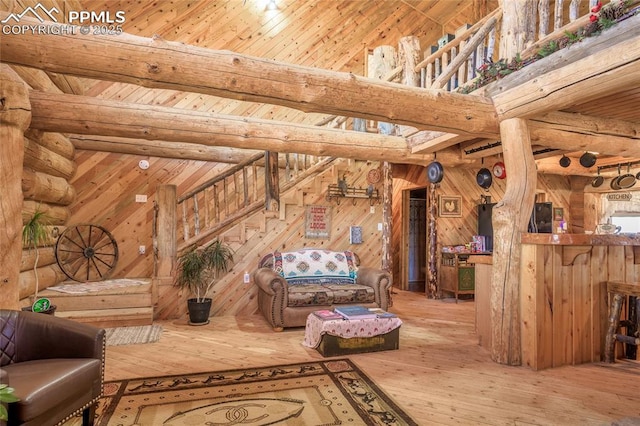 living room featuring wood-type flooring, wooden walls, wooden ceiling, and beam ceiling