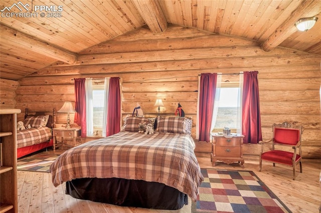 bedroom featuring multiple windows, hardwood / wood-style floors, log walls, and lofted ceiling with beams