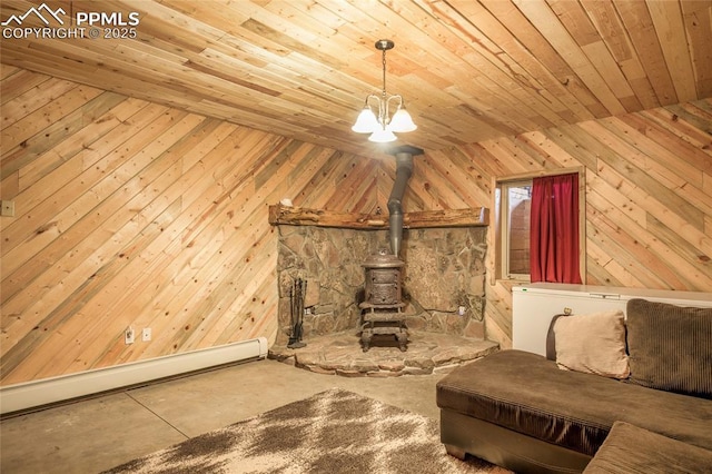 unfurnished living room with wood walls, a baseboard radiator, wooden ceiling, concrete floors, and a wood stove