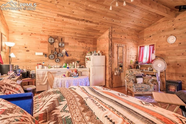 bedroom featuring vaulted ceiling with beams, wood walls, white refrigerator, wooden ceiling, and a wood stove