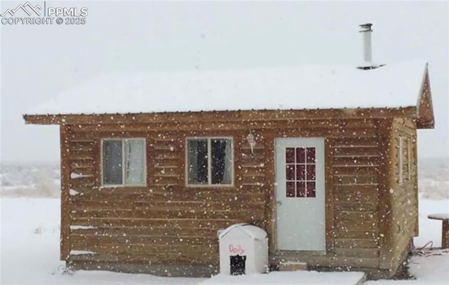 view of snowy exterior with electric panel