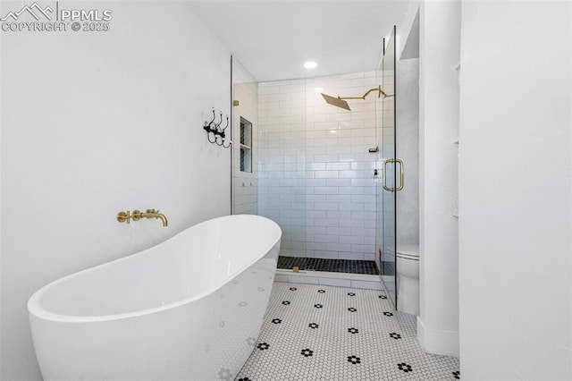 bathroom featuring toilet, plus walk in shower, and tile patterned flooring