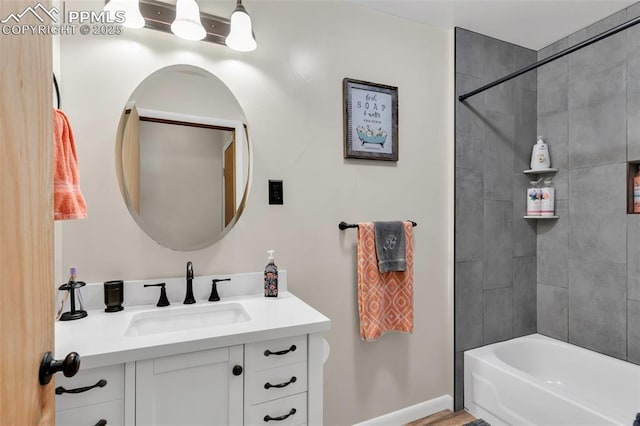 bathroom with vanity and tiled shower / bath combo