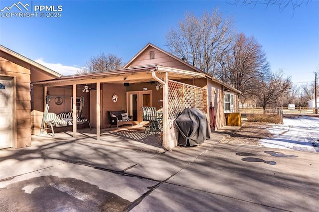 back of house featuring a patio area and ceiling fan