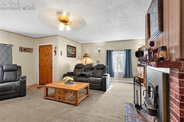 living room with ceiling fan, light colored carpet, and a textured ceiling