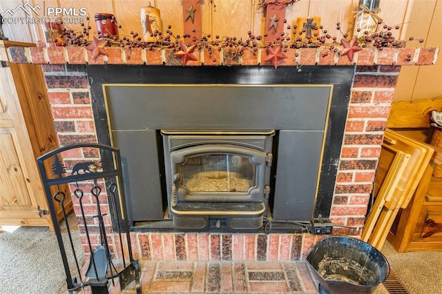 interior details featuring carpet floors and a wood stove