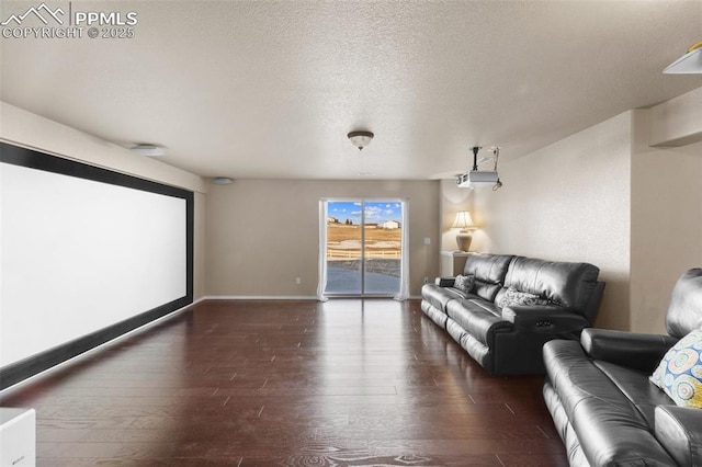 cinema with dark hardwood / wood-style flooring and a textured ceiling