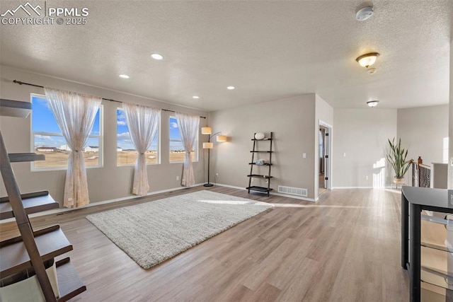 interior space featuring light hardwood / wood-style floors and a textured ceiling