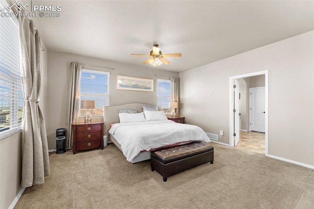 carpeted bedroom with multiple windows and ceiling fan