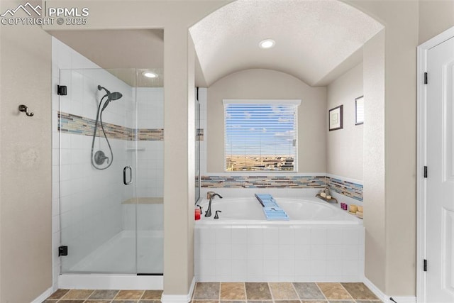 bathroom featuring separate shower and tub