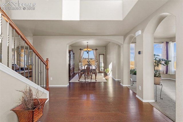 entryway featuring dark hardwood / wood-style floors and a chandelier