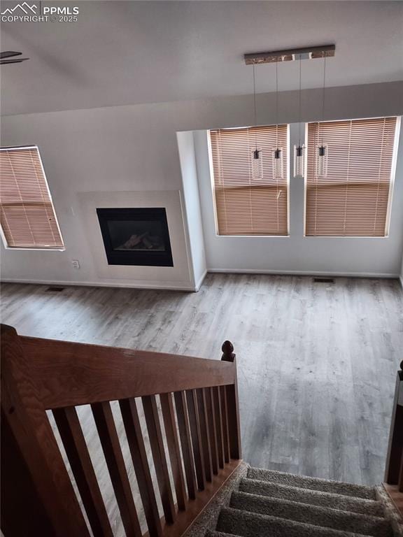 staircase with hardwood / wood-style floors