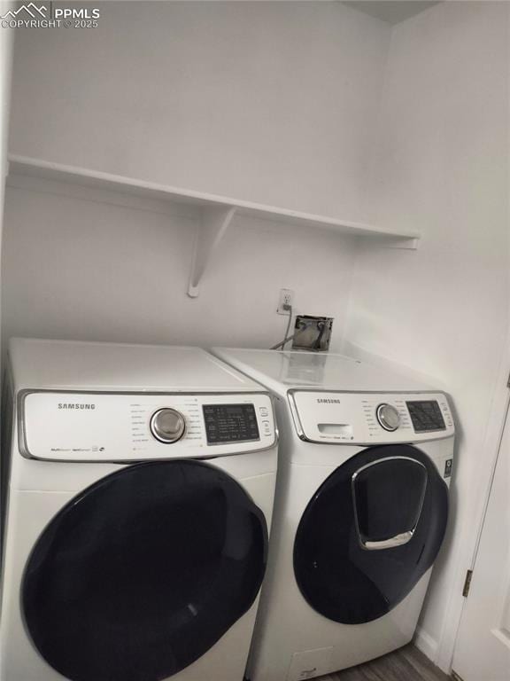 clothes washing area with independent washer and dryer