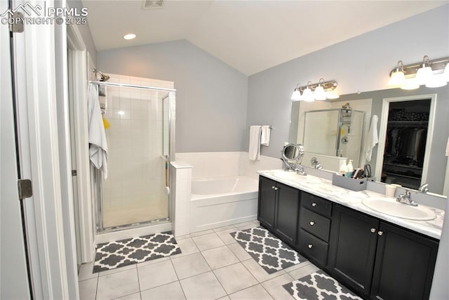 bathroom with lofted ceiling, vanity, tile patterned floors, and plus walk in shower