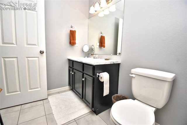 bathroom featuring vanity, tile patterned floors, and toilet