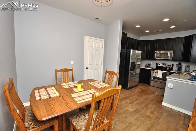 dining room with light wood-type flooring