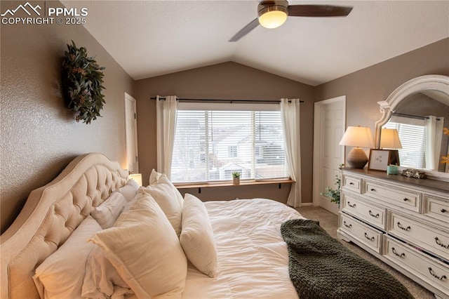 carpeted bedroom featuring lofted ceiling and ceiling fan