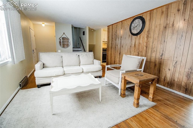 517 W Ramona Ave, Colorado Springs, CO 80905 - living room featuring light hardwood / wood-style floors and wood walls