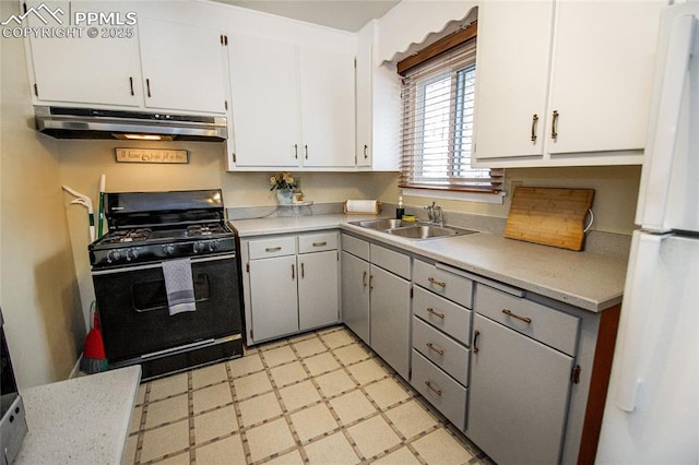517 W Ramona Ave, Colorado Springs, CO 80905 - kitchen with white cabinetry, black range with gas cooktop, sink, and white fridge