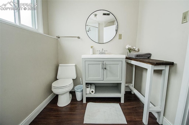 517 W Ramona Ave, Colorado Springs, CO 80905 - bathroom with vanity, hardwood / wood-style floors, and toilet