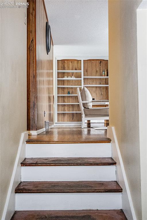 517 W Ramona Ave, Colorado Springs, CO 80905 - stairs featuring a textured ceiling
