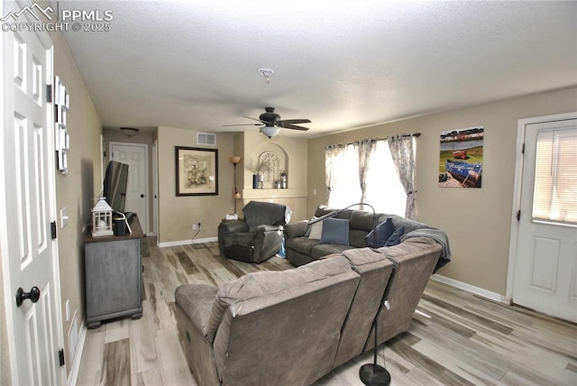 living room featuring light hardwood / wood-style floors and ceiling fan