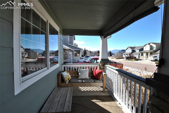 balcony with a mountain view and a porch