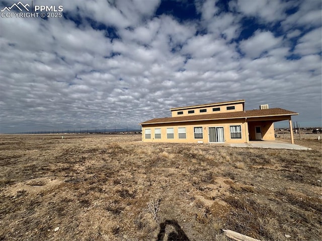 exterior space with a patio area and a rural view