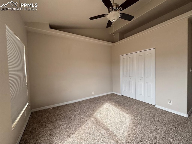 unfurnished bedroom with ceiling fan, carpet floors, vaulted ceiling, and a closet