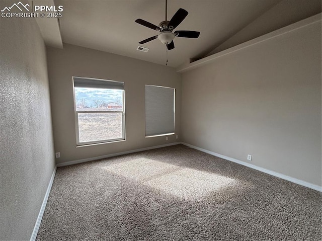 spare room featuring ceiling fan, lofted ceiling, and carpet