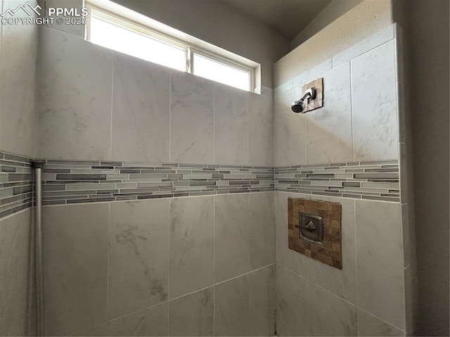 bathroom with tiled shower