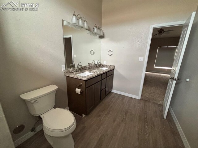 bathroom featuring vanity, hardwood / wood-style floors, and toilet