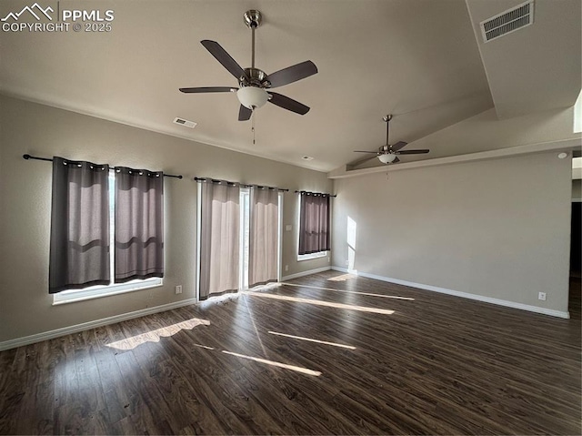 empty room featuring lofted ceiling, dark wood-type flooring, and ceiling fan