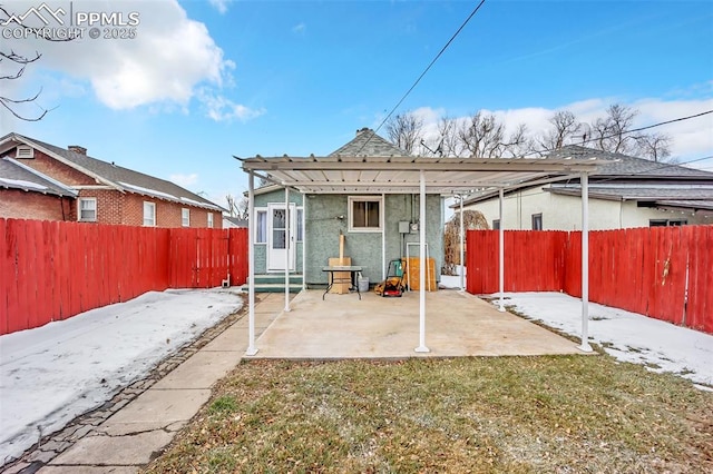 rear view of property featuring a pergola, a yard, and a patio area