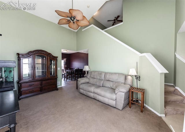 living room featuring ceiling fan, high vaulted ceiling, and light colored carpet