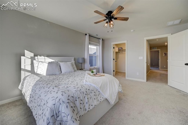 carpeted bedroom featuring a spacious closet, ceiling fan, and a closet