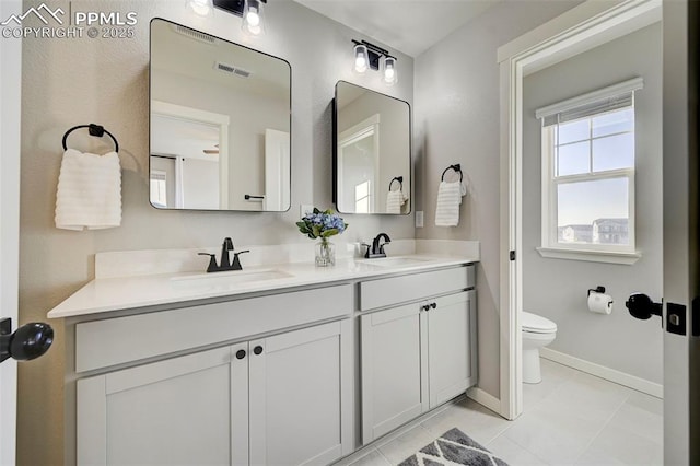 bathroom with vanity, tile patterned floors, and toilet