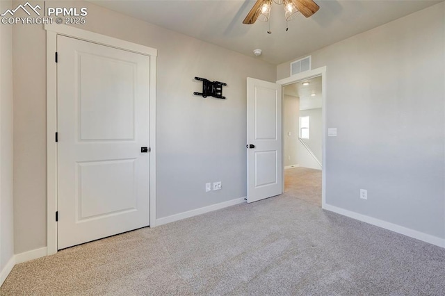 unfurnished bedroom with light carpet and ceiling fan