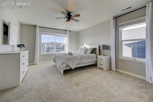 bedroom featuring light colored carpet and ceiling fan