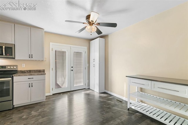 kitchen with french doors, dark wood-type flooring, white cabinetry, ceiling fan, and stainless steel appliances