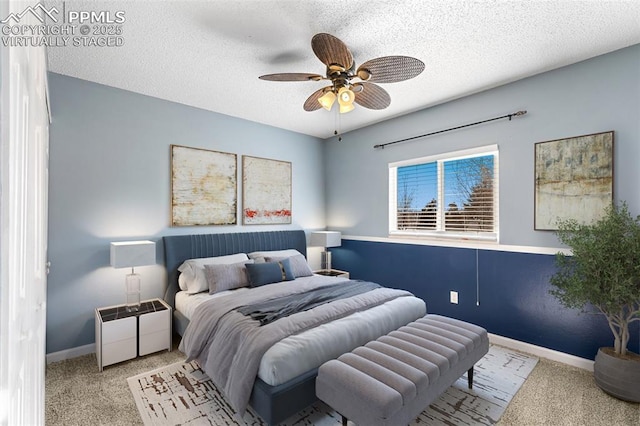 carpeted bedroom featuring ceiling fan and a textured ceiling