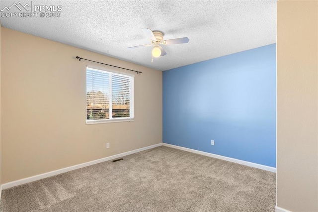 carpeted empty room featuring a textured ceiling and ceiling fan