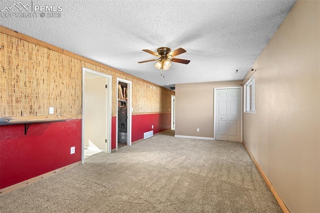 interior space featuring a textured ceiling and ceiling fan