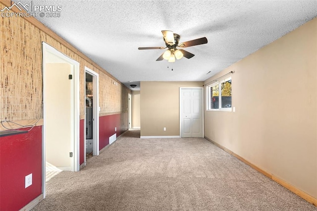 unfurnished bedroom featuring carpet, a textured ceiling, and a closet