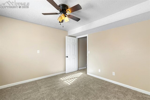 empty room with ceiling fan, carpet, and a textured ceiling