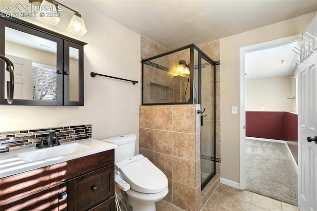 bathroom with tile patterned flooring, backsplash, vanity, and walk in shower