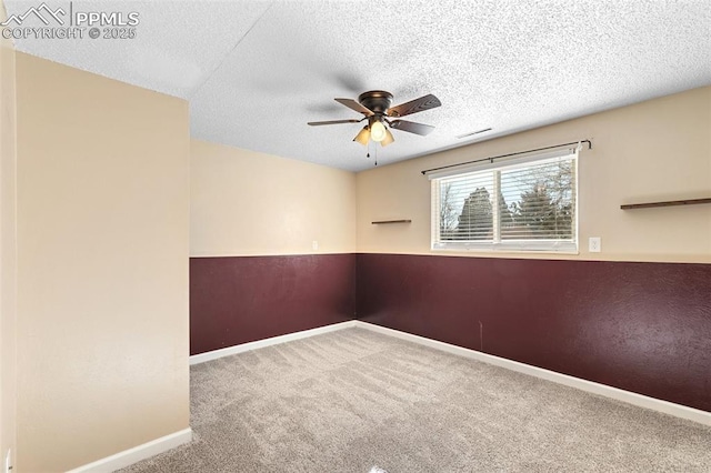 carpeted spare room with ceiling fan and a textured ceiling