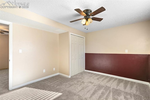 unfurnished bedroom with light carpet, ceiling fan, a closet, and a textured ceiling